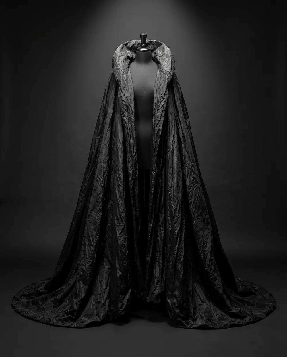 The Night Cape on a black dress form: a floor-length black taffeta cape with a high collar