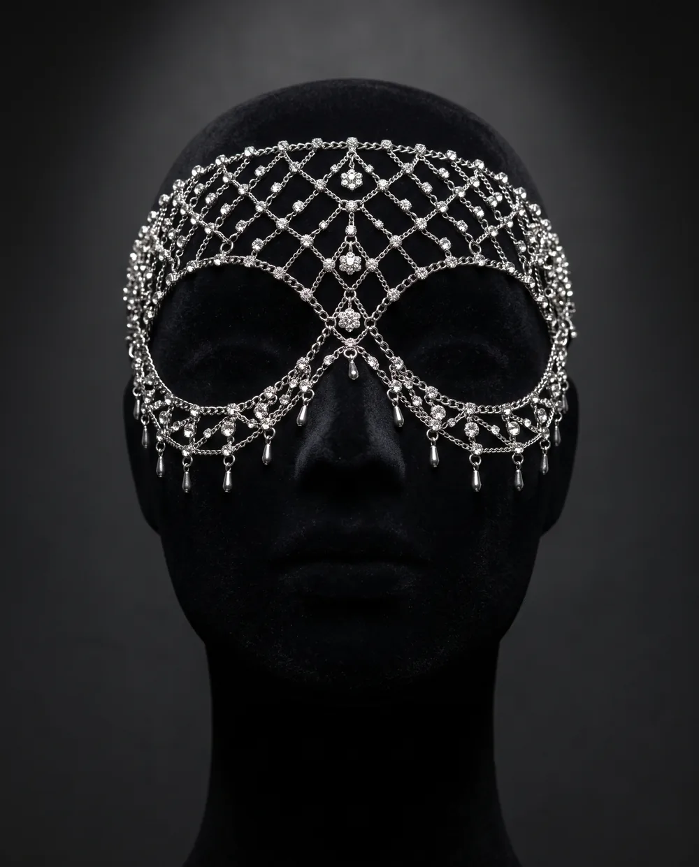 The Crystal Veil on a black velvet head form: a net of silver chain and crystals over the forehead and eyes