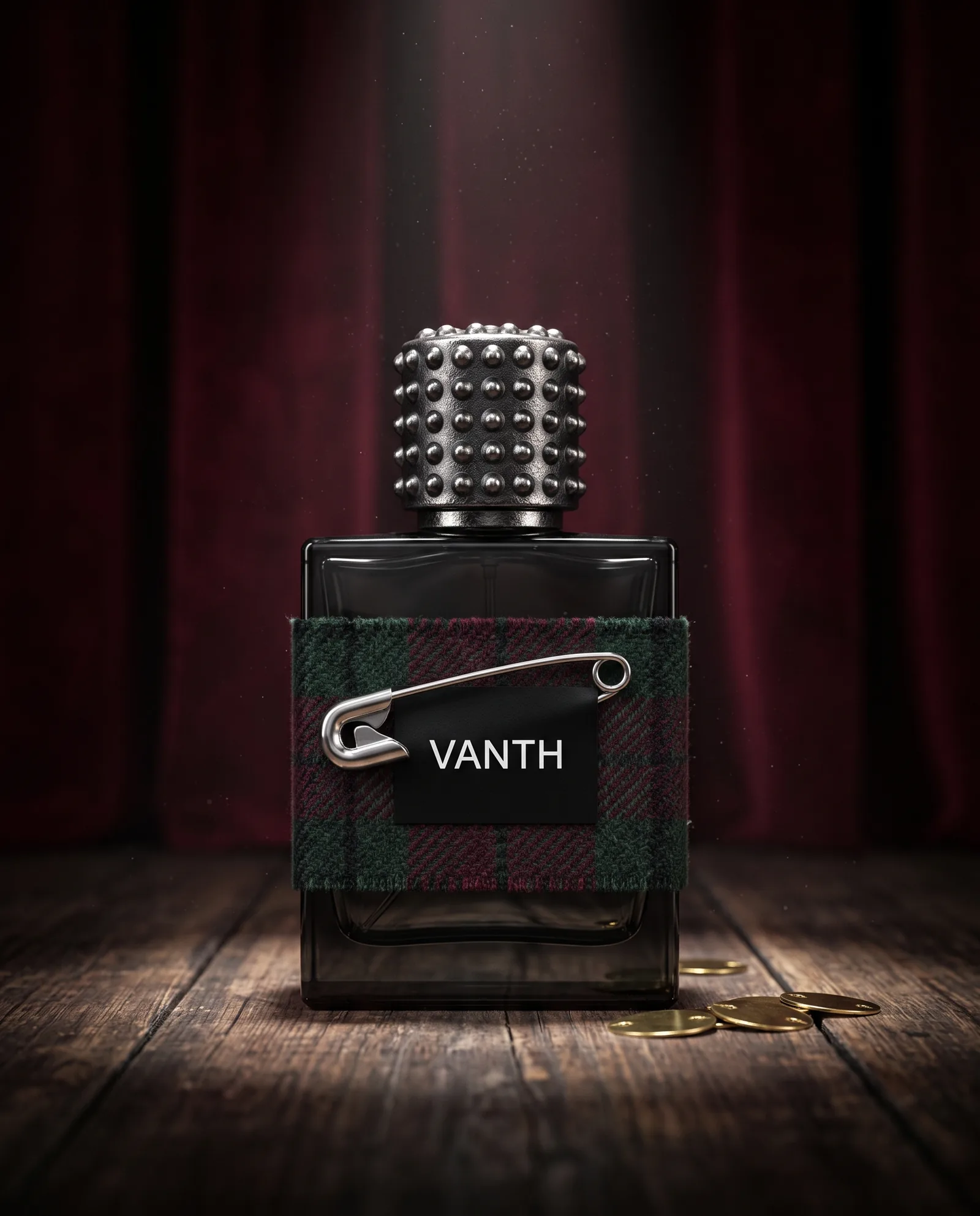 A square bottle of smoked black glass wrapped in a band of tartan held by a silver safety pin, with a studded cap, on worn stage boards